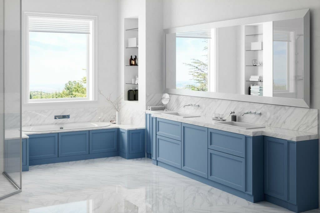 Luxury bathroom with blue cabinetry and marble countertops